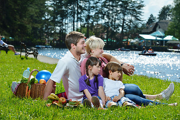 Image showing Happy family playing together in a picnic outdoors