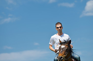 Image showing man ride horse