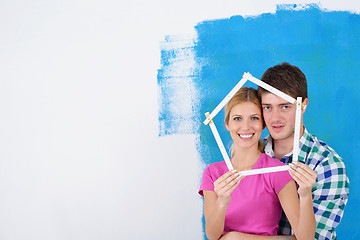 Image showing happy couple paint wall at new home