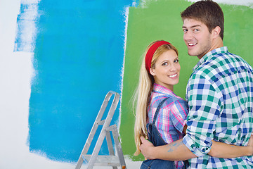 Image showing happy couple paint wall at new home