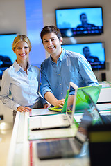 Image showing Young couple in consumer electronics store