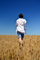 Image showing young woman in wheat field at summer