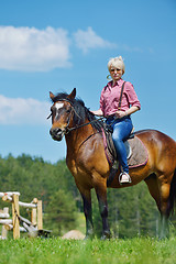 Image showing happy woman  ride  horse