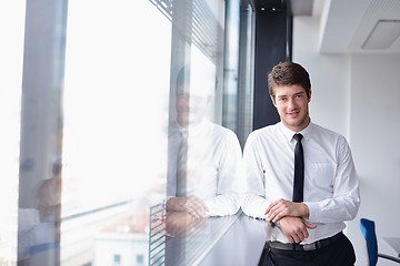 Image showing business man  on a meeting in offce with colleagues in backgroun