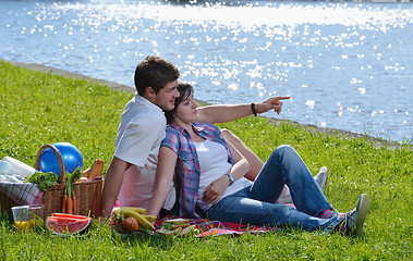 Image showing happy young couple having a picnic outdoor