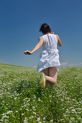 Image showing Young happy woman in green field