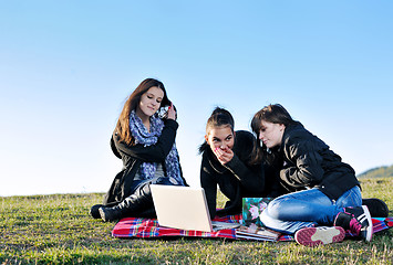 Image showing group of teens working on laptop outdoor