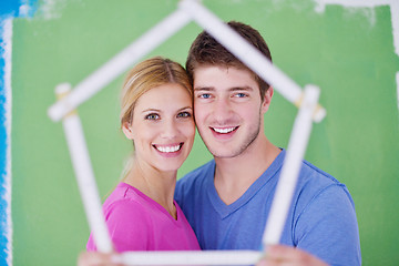 Image showing happy couple paint wall at new home