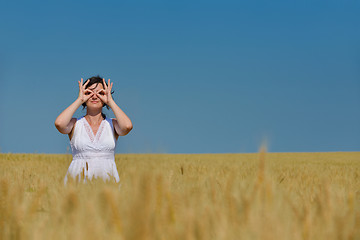 Image showing young woman in wheat field at summer