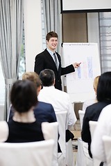 Image showing Young  business man giving a presentation on conference