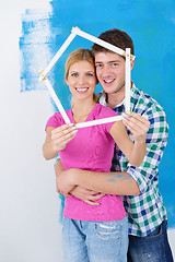 Image showing happy couple paint wall at new home