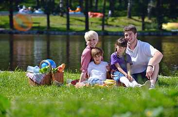 Image showing Happy family playing together in a picnic outdoors