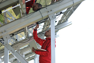 Image showing engineer using laptop at solar panels plant field