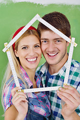 Image showing happy couple paint wall at new home