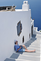 Image showing Greek woman on the streets of Oia, Santorini, Greece