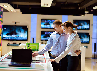 Image showing Young couple in consumer electronics store