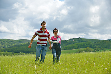 Image showing Portrait of romantic young couple smiling together outdoor