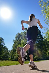 Image showing Young beautiful  woman jogging at morning in park