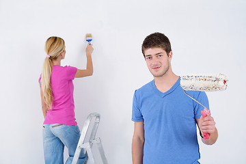 Image showing happy couple paint wall at new home