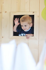 Image showing happy child in a window