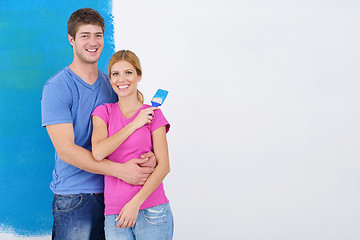 Image showing happy couple paint wall at new home