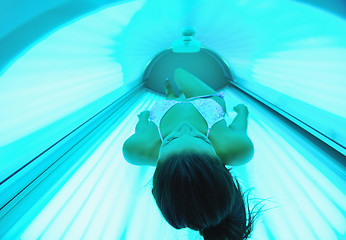 Image showing Beautiful young woman tanning in solarium