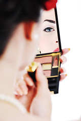 Image showing beautiful young woman applying makeup