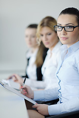 Image showing business woman standing with her staff in background