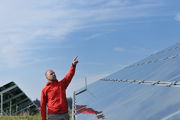 Image showing engineer using laptop at solar panels plant field