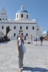 Image showing Greek woman on the streets of Oia, Santorini, Greece