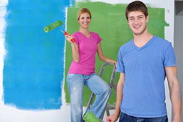 Image showing happy couple paint wall at new home