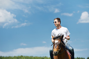 Image showing man ride horse