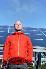 Image showing engineer using laptop at solar panels plant field