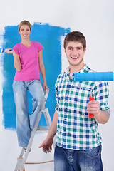 Image showing happy couple paint wall at new home