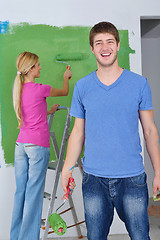 Image showing happy couple paint wall at new home