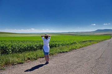 Image showing Young happy woman in green field