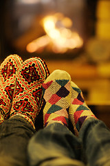 Image showing Young romantic couple sitting and relaxing in front of fireplace