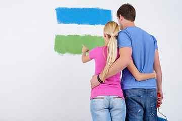 Image showing happy couple paint wall at new home