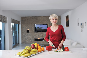 Image showing happy  beautiful blonde  woman prepare food in  the kitchen