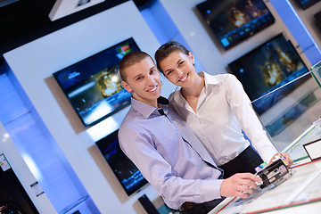 Image showing Young couple in consumer electronics store