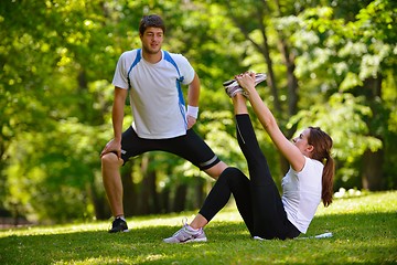 Image showing Couple doing stretching exercise  after jogging