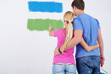 Image showing happy couple paint wall at new home