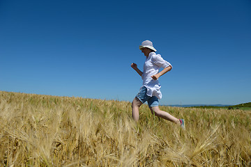 Image showing young woman in wheat field at summer