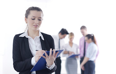 Image showing business woman standing with her staff in background