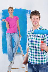 Image showing happy couple paint wall at new home