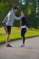 Image showing Couple doing stretching exercise  after jogging