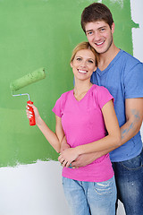 Image showing happy couple paint wall at new home