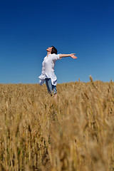 Image showing young woman in wheat field at summer