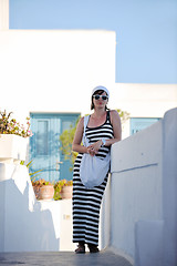 Image showing Greek woman on the streets of Oia, Santorini, Greece