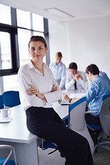 Image showing business woman with her staff in background at office